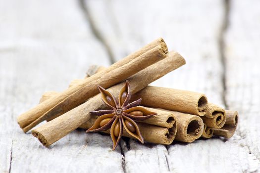 cinnamon sticks and anise on wooden background