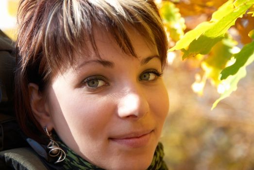 Beautiful girl's portrait with soft autumn background