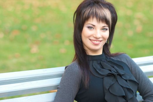 Portrait of beautiful girl sitting on the bench