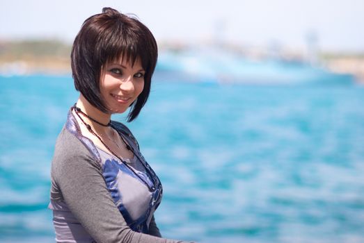 Pretty brunette young girl near the sea