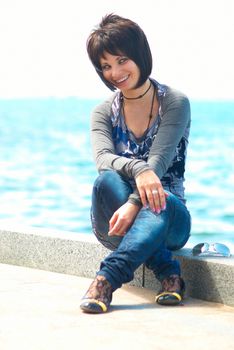 Pretty brunette young girl near the sea