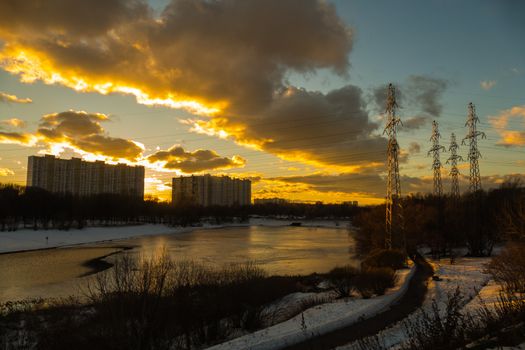 Sunset over the city, lake, houses, power lines, winter 2016