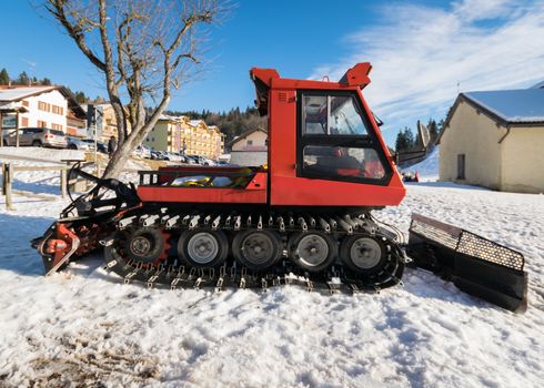 Snowcat parked at the end of a ski slope.