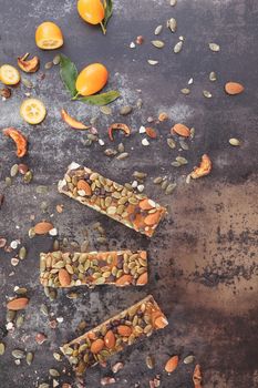 Healthy nuts and kumquat granola bars. Top view, vintage toned image, blank space