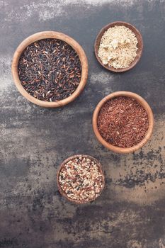 Still life with four different types of rice. Top view, vintage toned image, blank space