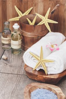Spa still life with sea salt, essential oils and starfish. Macro selective focus with retro style processing, blank space