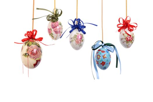 Colorful Easter eggs with flowers and handcrafted by hand. Ribbons and white background.