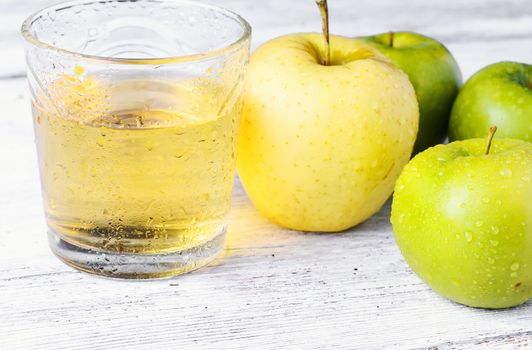 Fresh juice from the fruit green apple on light background