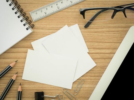 blank business cards with stationary ,laptop computer  on the desk. view top