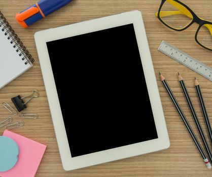 tablet computer and stationery on desk. education concept , view top.