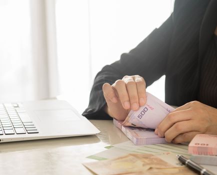 Bank employees are counting banknotes received or paid to customers.