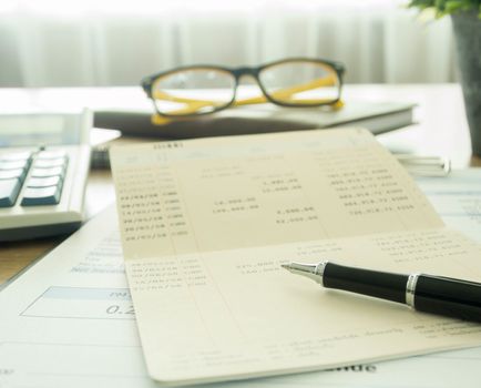 Accountants desk with pen and bank book. selective focus.