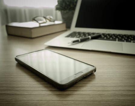smart phone on work desk. technology concept. selective focus.