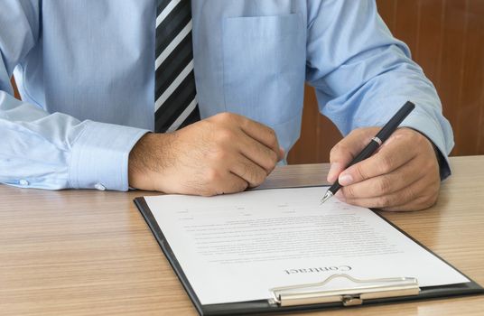 Businessman is signing a contract.  business concept