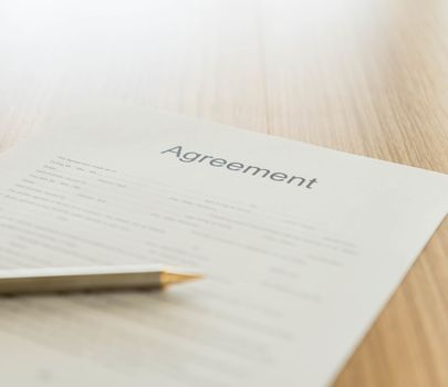 Closeup the words agreement on formal paper. agreement concept