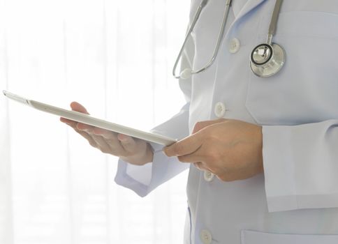 male doctor using digital tablet at work