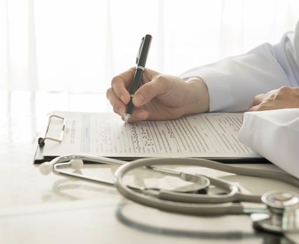 close-up of doctor taking notes on hospital
