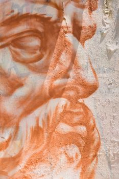 Graffiti of an old man profile on the white facade of a house in Plaka part of Athens.