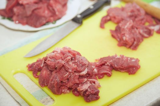 Raw meat sliced on a kitchen table. Close-up view