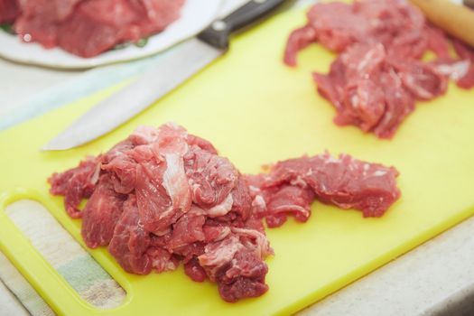 Raw meat sliced on a kitchen table. Close-up view