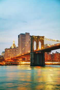 Lower Manhattan cityscape with the Brooklyn bridge at sunset