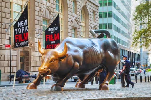 NEW YORK CITY - September 5: Charging Bull sculpture on September 5, 2015 in New York City. The sculpture is both a popular tourist destination, as well as "one of the most iconic images of New York".