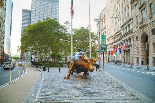 NEW YORK CITY - September 5: Charging Bull sculpture on September 5, 2015 in New York City. The sculpture is both a popular tourist destination, as well as "one of the most iconic images of New York".