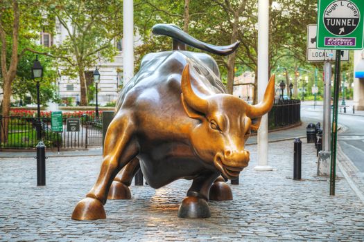 NEW YORK CITY - September 5: Charging Bull sculpture on September 5, 2015 in New York City. The sculpture is both a popular tourist destination, as well as "one of the most iconic images of New York".