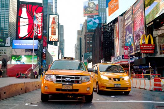 NEW YORK CITY - SEPTEMBER 04: Yellow cabs at Times square in the morning on October 4, 2015 in New York City. It's major commercial intersection and neighborhood in Midtown Manhattan at the junction of Broadway and 7th Avenue.