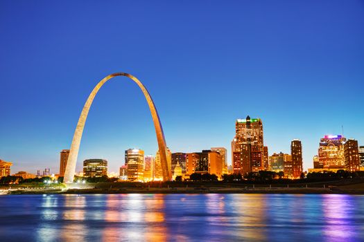 Downtown St Louis, MO with the Old Courthouse and the Gateway Arch at sunset