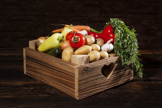 Organic seasonal vegetable in rustic wooden crate. Healthy vegetable eating. 