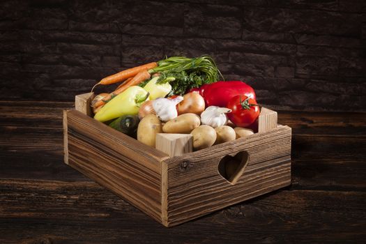 Organic seasonal vegetable in rustic wooden crate. Healthy vegetable eating. 
