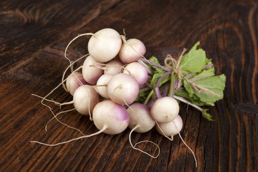 Ripe fresh radish bundle on wooden background. Seasonal organic vegetable harvest. Farmer market.