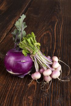 Ripe fresh radish bundle on wooden background. Seasonal organic vegetable harvest. Farmer market.