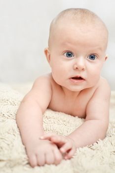 Sweet small blue eyes baby on the a towel