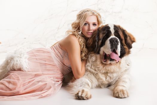 Young woman and big st.bernard in the studio