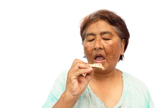 Old hoary woman open mouth and prepare to put a denture ( isolated background )