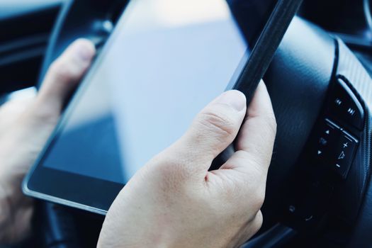 using a digital tablet inside of a car.communication technology