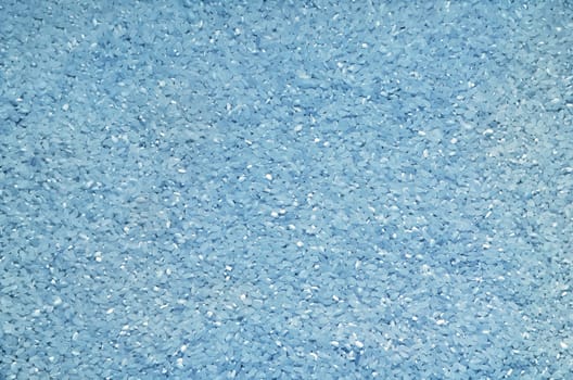 Textured background of rice grains scattered on the surface