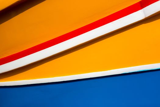 Abstract close up view of the vibrant colours and design usually used on the traditional Maltese fishing boat, the "Dghajsa" or "Luzzu".