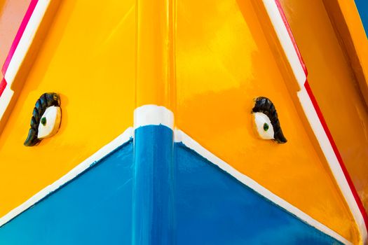 Abstract close up view of the vibrant colours and design usually used on the traditional Maltese fishing boat, the "Dghajsa" or "Luzzu".