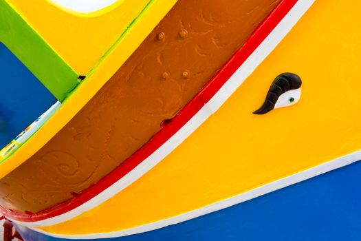 Abstract close up view of the vibrant colours and design usually used on the traditional Maltese fishing boat, the "Dghajsa" or "Luzzu".