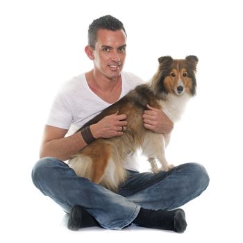 man and shetland sheepdog in front of white background