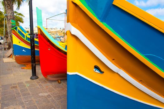 Abstract close up view of the vibrant colours and design usually used on the traditional Maltese fishing boat, the "Dghajsa" or "Luzzu".