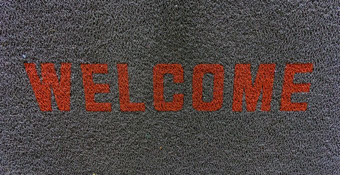 Mat word welcome.A doormat . With a message welcoming visitors.