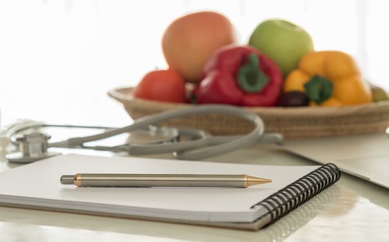 closeup pen on desk's nutritionists in office.