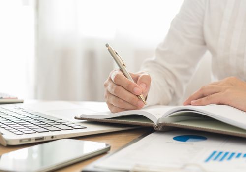 businessman record data on  to schedule a meeting or event