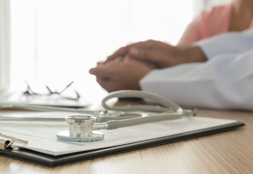 stethoscope and medical documentation  with doctor and patient background