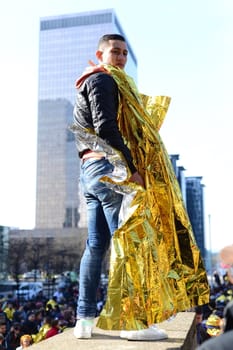 BELGIUM, Brussels: A man wearing a survival blanket is seen during the European March for Refugee Rights, in Brussels, on February 27, 2016. Hundreds of demonstrators, including migrants or undocumented workers, demanded the European authorities to take action to secure safe passage routes for refugees.