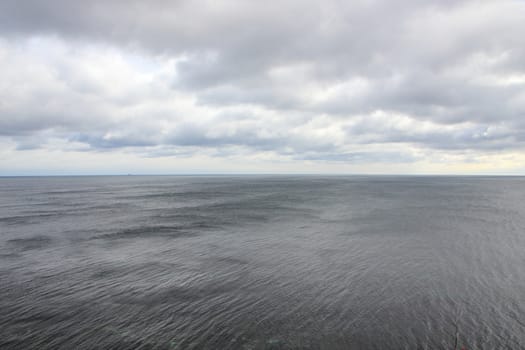 Ocean Horizon with Black Water and Dramatic Clouds Background